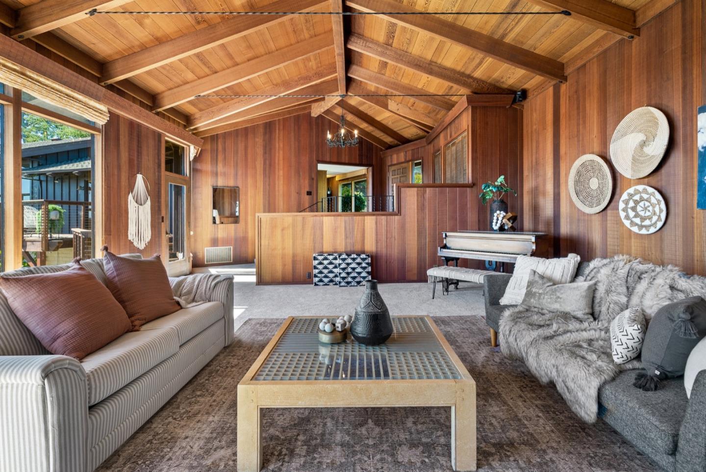 390 Rancho Soquel Drive Soquel, CA 95073 - Photo 10 of 97 a living room with furniture a clock on wall and a large window