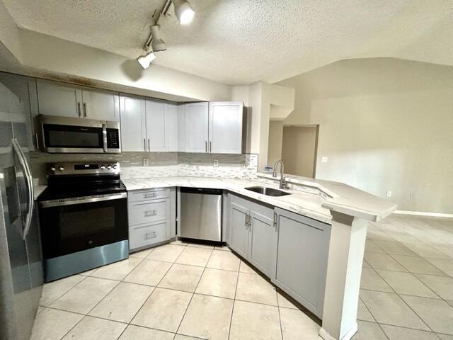 741 North Pine Island Road, Unit 303 Plantation, FL 33324 - Photo 8 of 32 a kitchen with stainless steel appliances granite countertop a sink and a stove