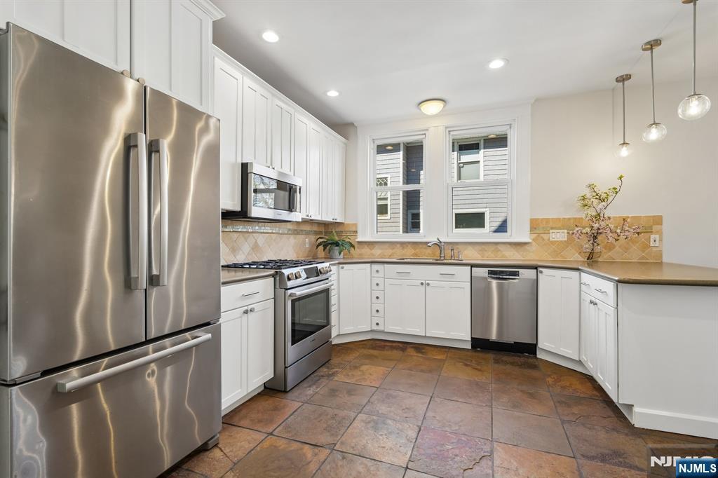 115 Park Street Montclair, NJ 07042 - Photo 20 of 45 a kitchen with stainless steel appliances granite countertop a refrigerator sink and stove