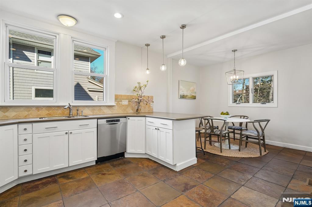 115 Park Street Montclair, NJ 07042 - Photo 22 of 45 a large white kitchen with granite countertop a sink white cabinets and a window