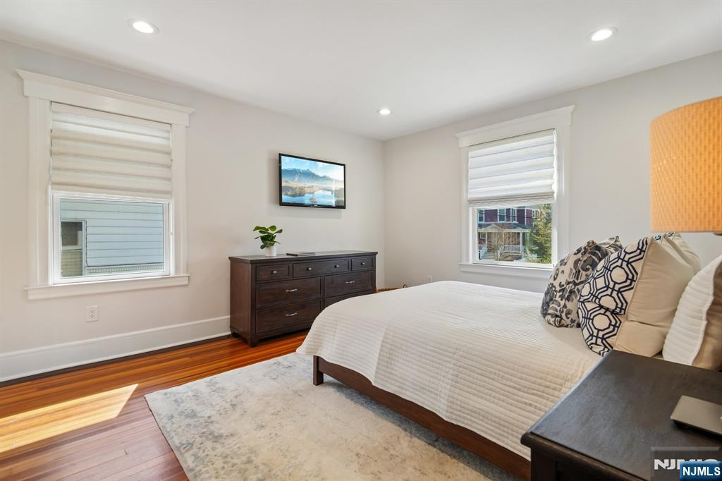115 Park Street Montclair, NJ 07042 - Photo 25 of 45 a bedroom with a bed and wooden floor