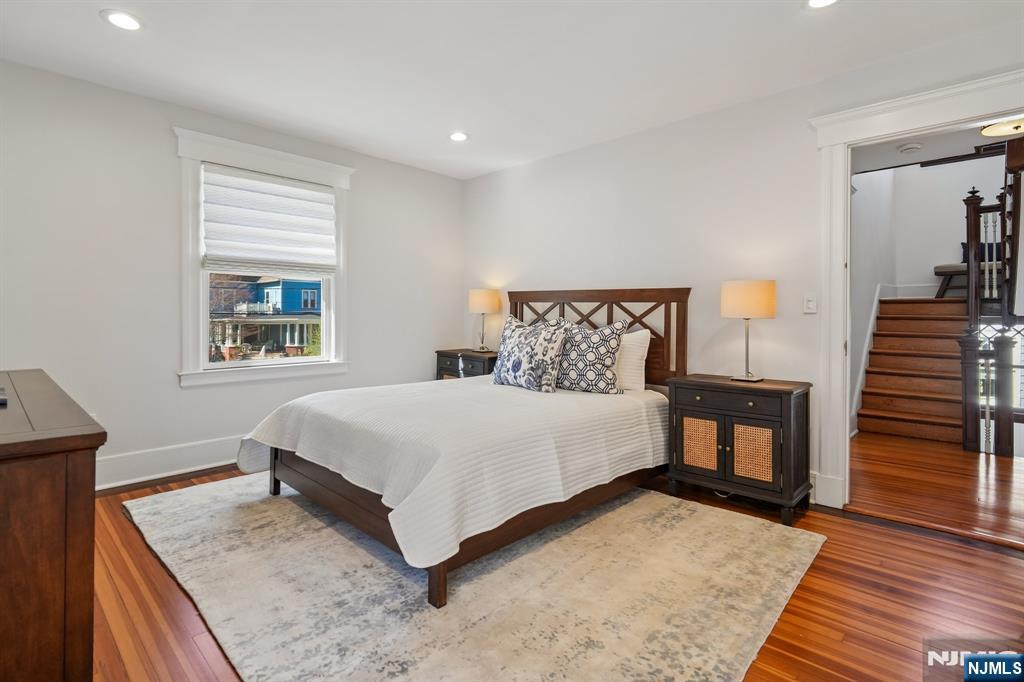 115 Park Street Montclair, NJ 07042 - Photo 26 of 45 a bedroom with a bed and a dresser with wooden floor