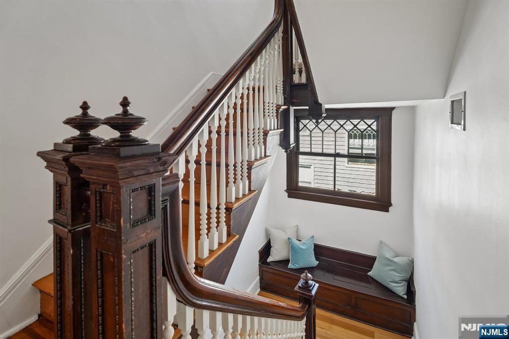 115 Park Street Montclair, NJ 07042 - Photo 34 of 45 a view of staircase with lots of frames on wall and a window
