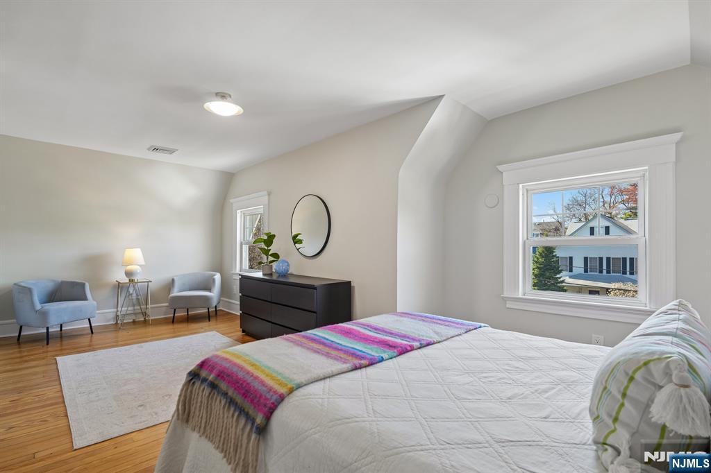 115 Park Street Montclair, NJ 07042 - Photo 35 of 45 a bedroom with a large bed and wooden floor