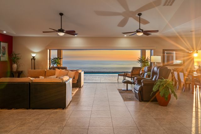 a very nice looking room with a dining table a chandelier