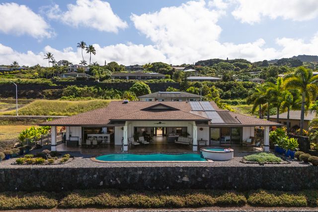 a view of house with garden and tall trees