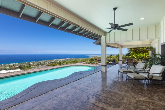 a view of a patio with a table chairs and a yard