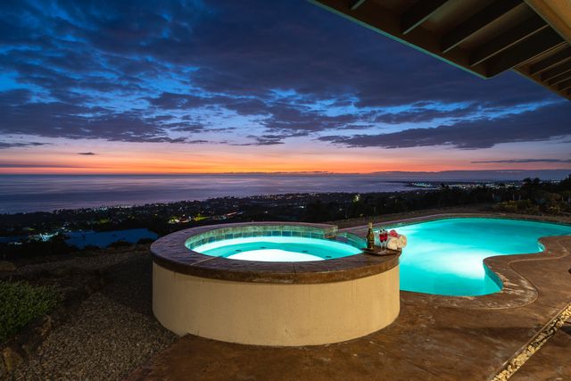 a view of a swimming pool and a yard
