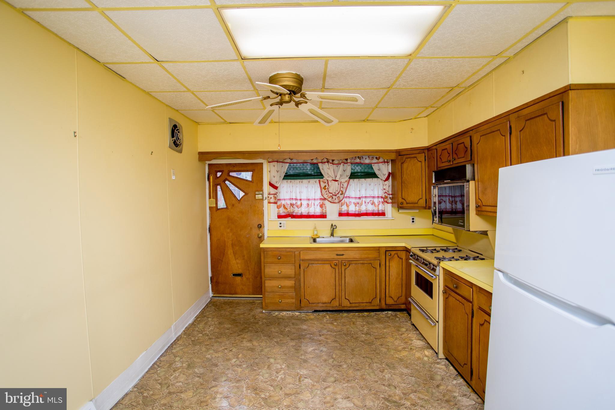 2116 North Natrona Street Philadelphia, PA 19121 - Photo 15 of 53 a kitchen with stainless steel appliances a stove a sink and a refrigerator