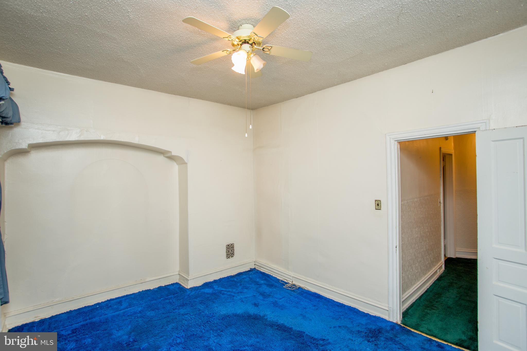 2116 North Natrona Street Philadelphia, PA 19121 - Photo 19 of 53 an empty room with wooden floor and a ceiling fan