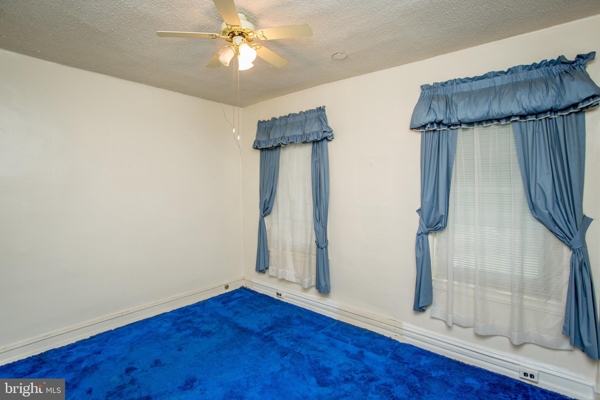 2116 North Natrona Street Philadelphia, PA 19121 - Photo 21 of 53 a view of empty room with wooden floor and fan