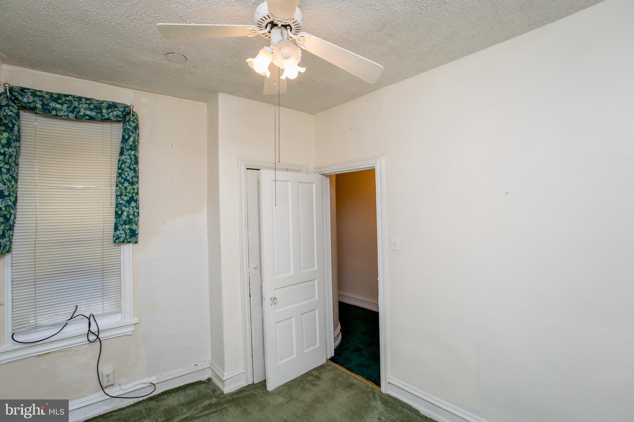 2116 North Natrona Street Philadelphia, PA 19121 - Photo 23 of 53 a view of a hallway with closet and a chandelier fan