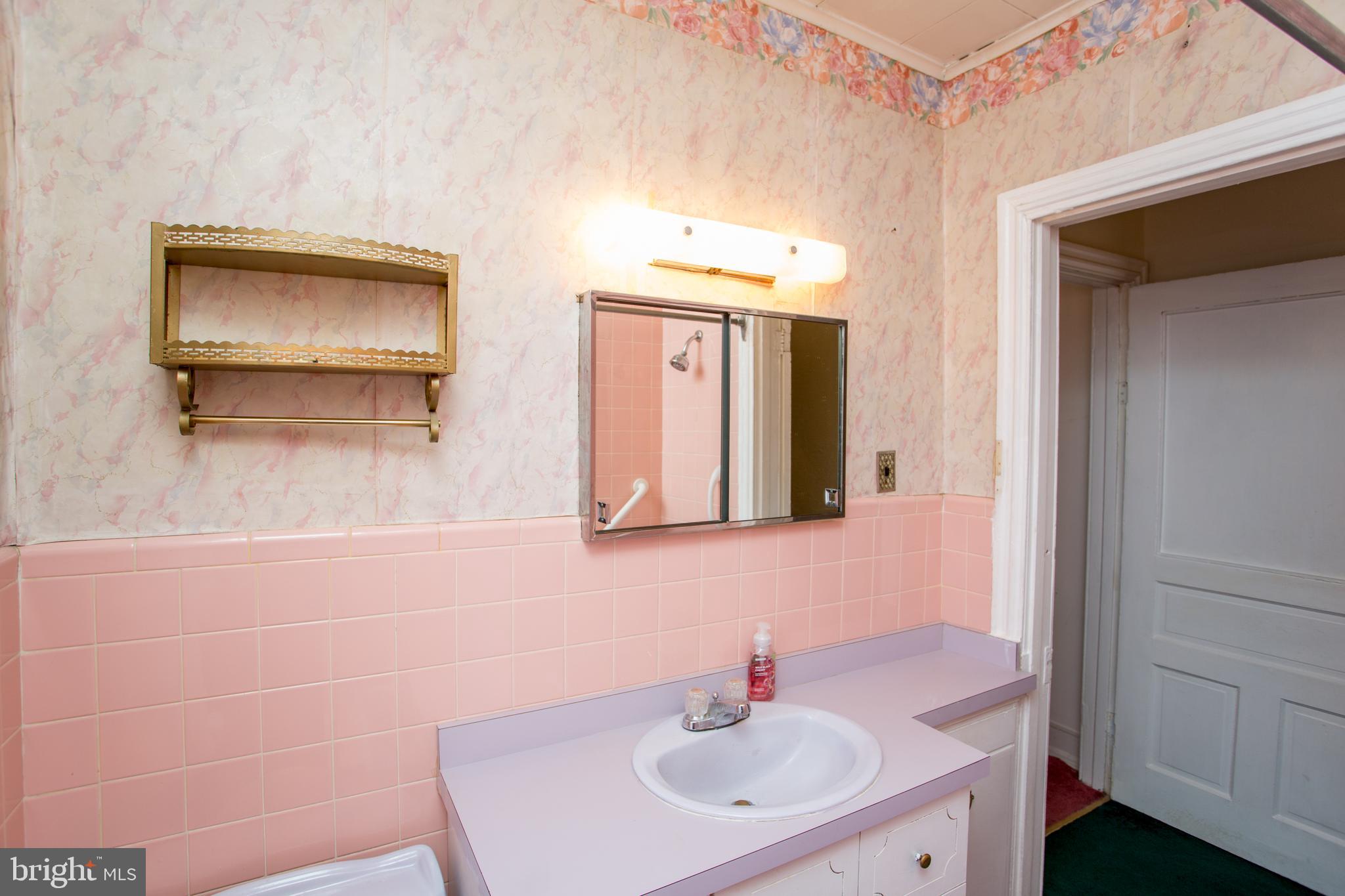2116 North Natrona Street Philadelphia, PA 19121 - Photo 27 of 53 a bathroom with a sink and a mirror