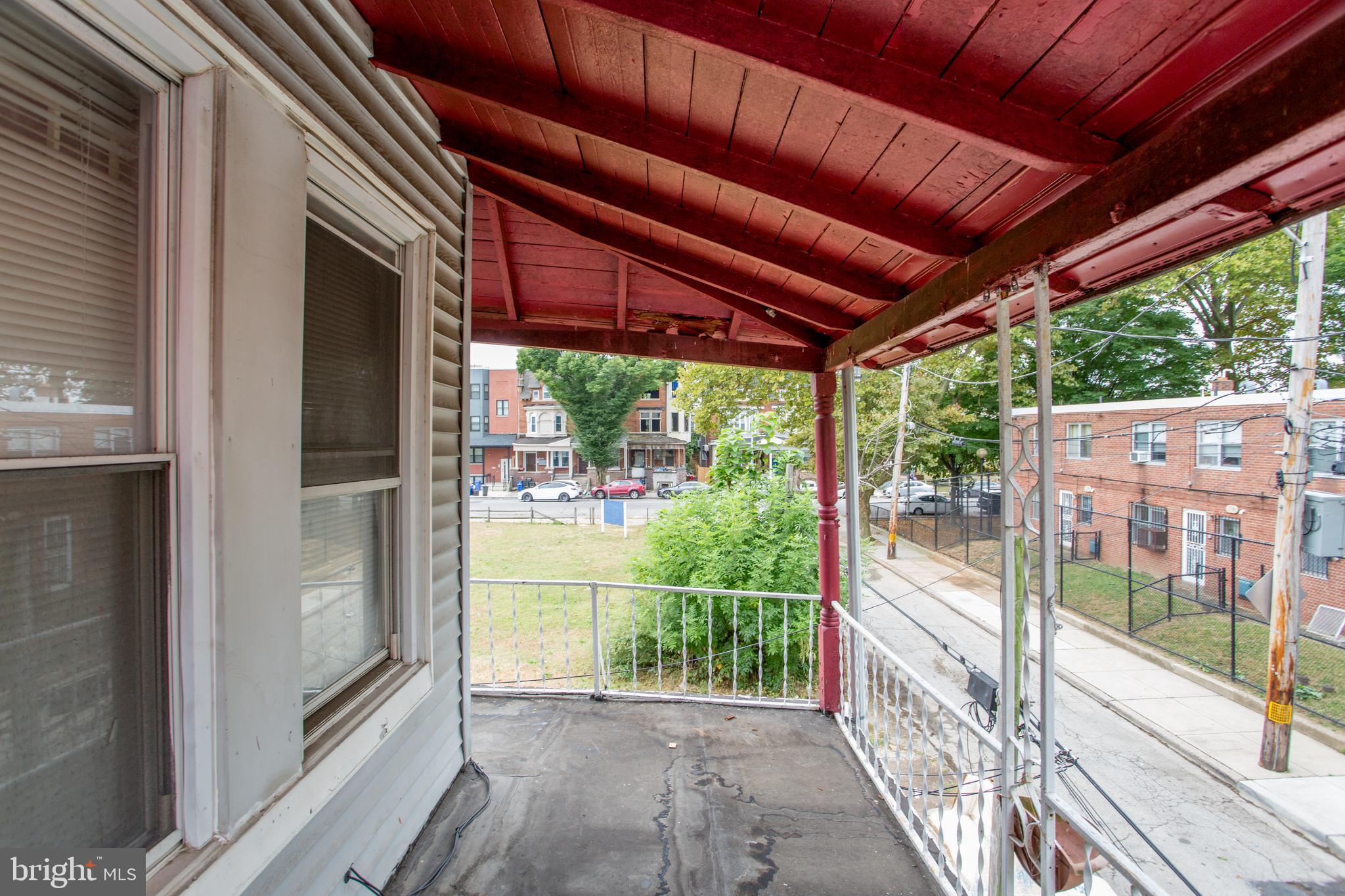 2116 North Natrona Street Philadelphia, PA 19121 - Photo 35 of 53 a view of a backyard with a large tree and wooden floor