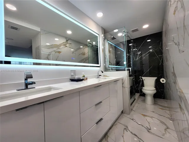 a bathroom with a sink double vanity and a toilet