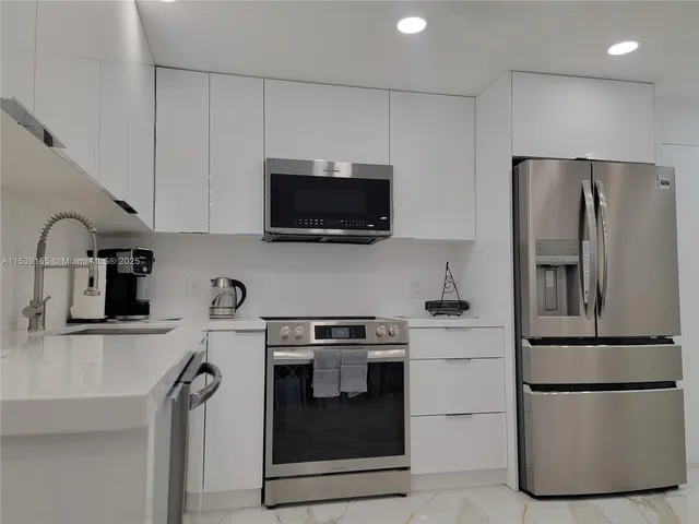 a kitchen with a refrigerator stove and microwave