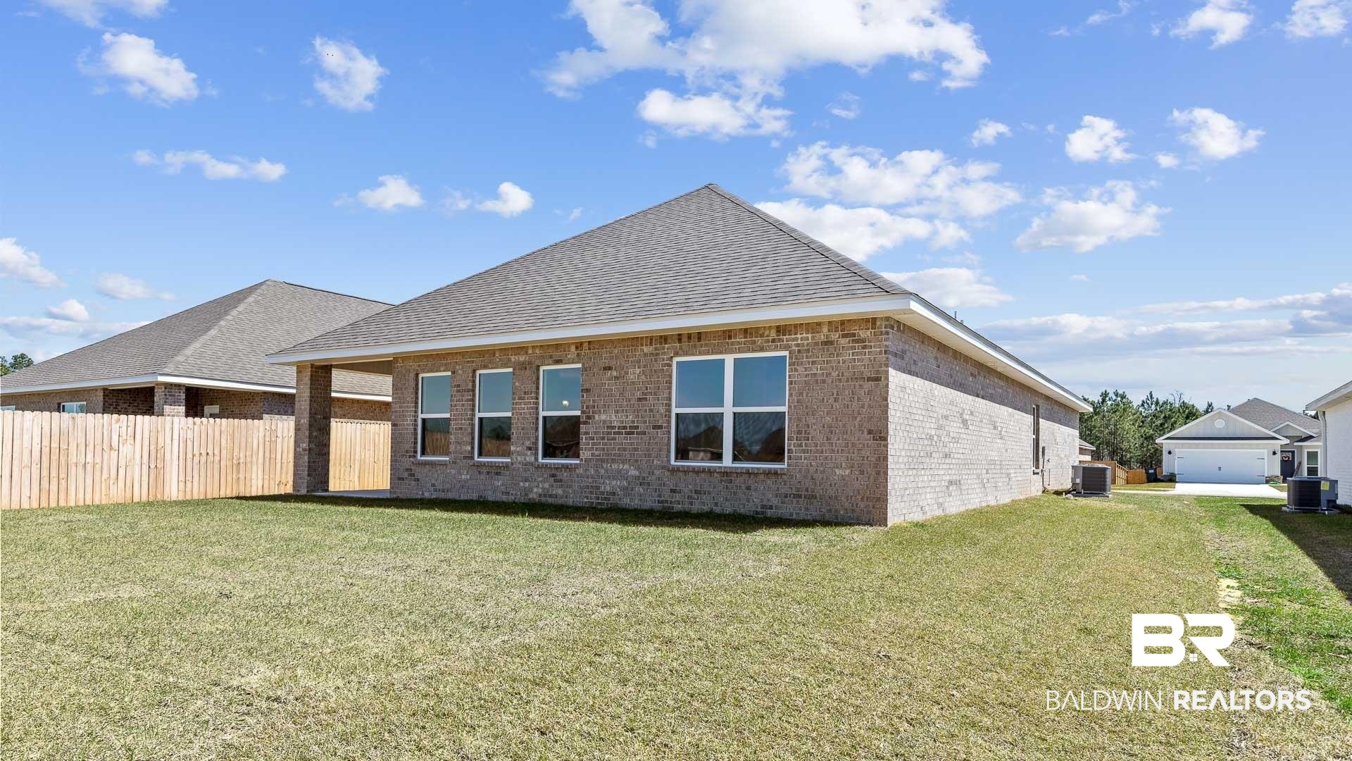 12931 Grand Rpds Road Fairhope, AL 36532 - Photo 4 of 33 Rear view of property featuring cooling unit, brick siding, and a yard