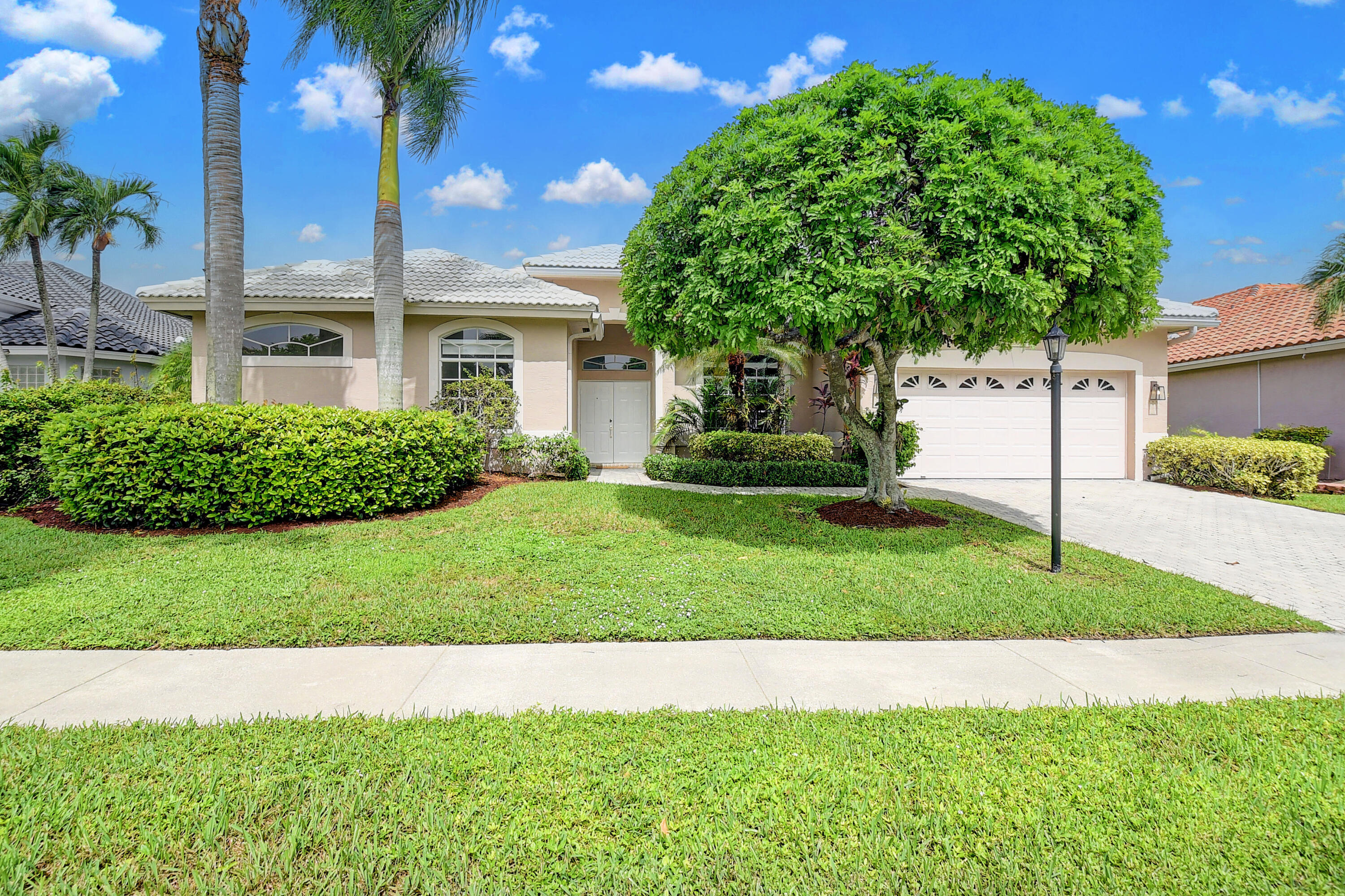 12373 Rockledge Circle Boca Raton, FL 33428 - Photo 1 of 68 a front view of a house with a yard