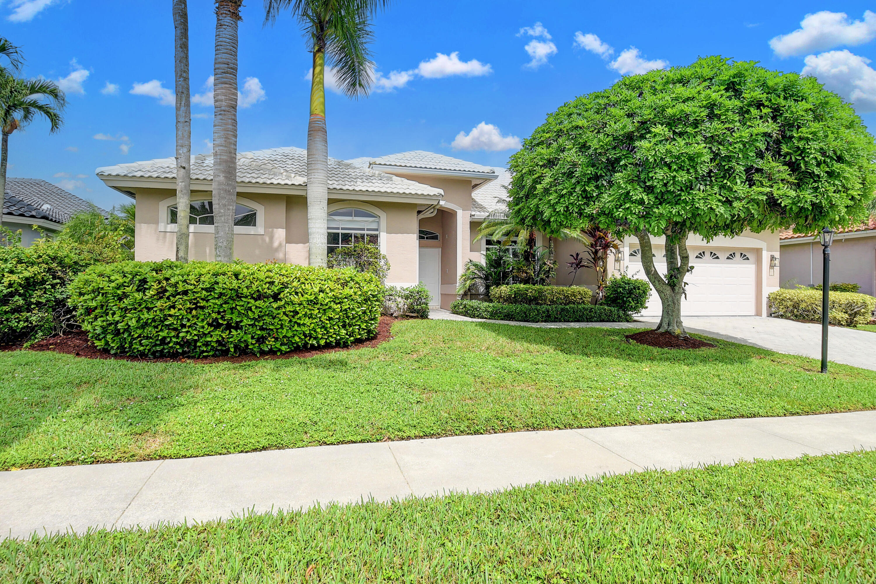 12373 Rockledge Circle Boca Raton, FL 33428 - Photo 2 of 68 a front view of a house with a yard
