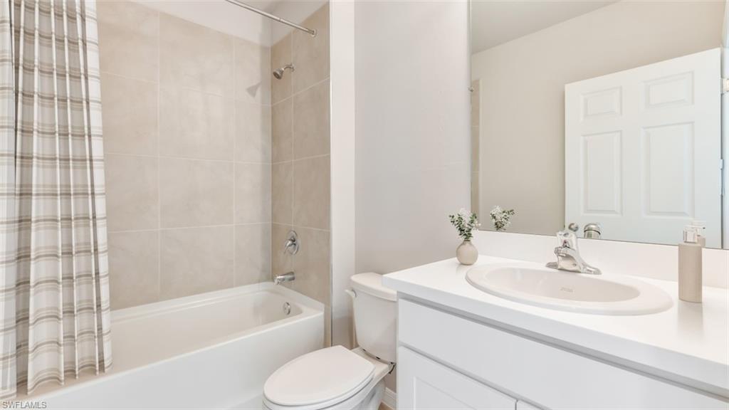 17764 Shade Tree Loop Punta Gorda, FL 33982 - Photo 10 of 12 Bathroom featuring vanity and shower / bathtub combination with curtain