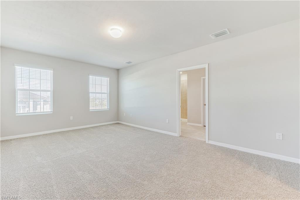 17764 Shade Tree Loop Punta Gorda, FL 33982 - Photo 12 of 48 an empty room with windows and closet