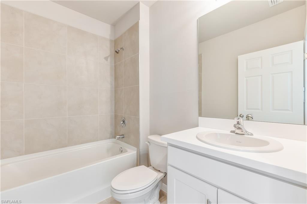 17764 Shade Tree Loop Punta Gorda, FL 33982 - Photo 18 of 48 a bathroom with a sink a toilet and a bathtub