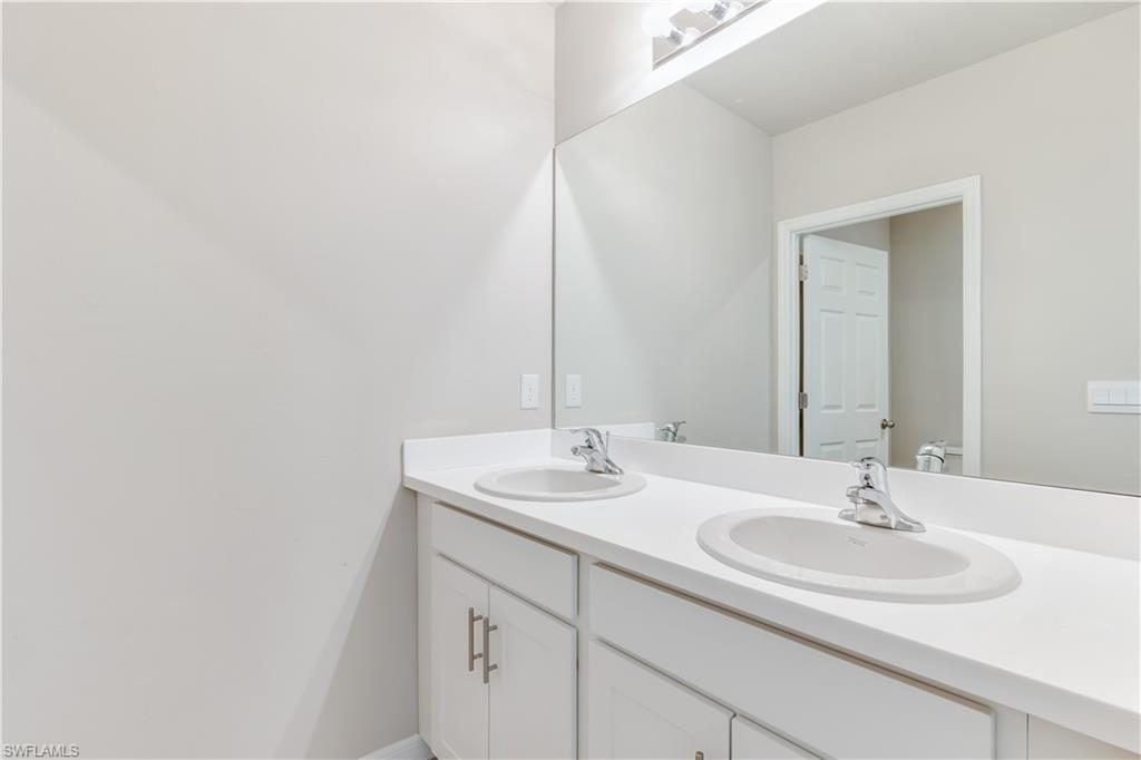 17764 Shade Tree Loop Punta Gorda, FL 33982 - Photo 19 of 48 a bathroom with a sink and a mirror