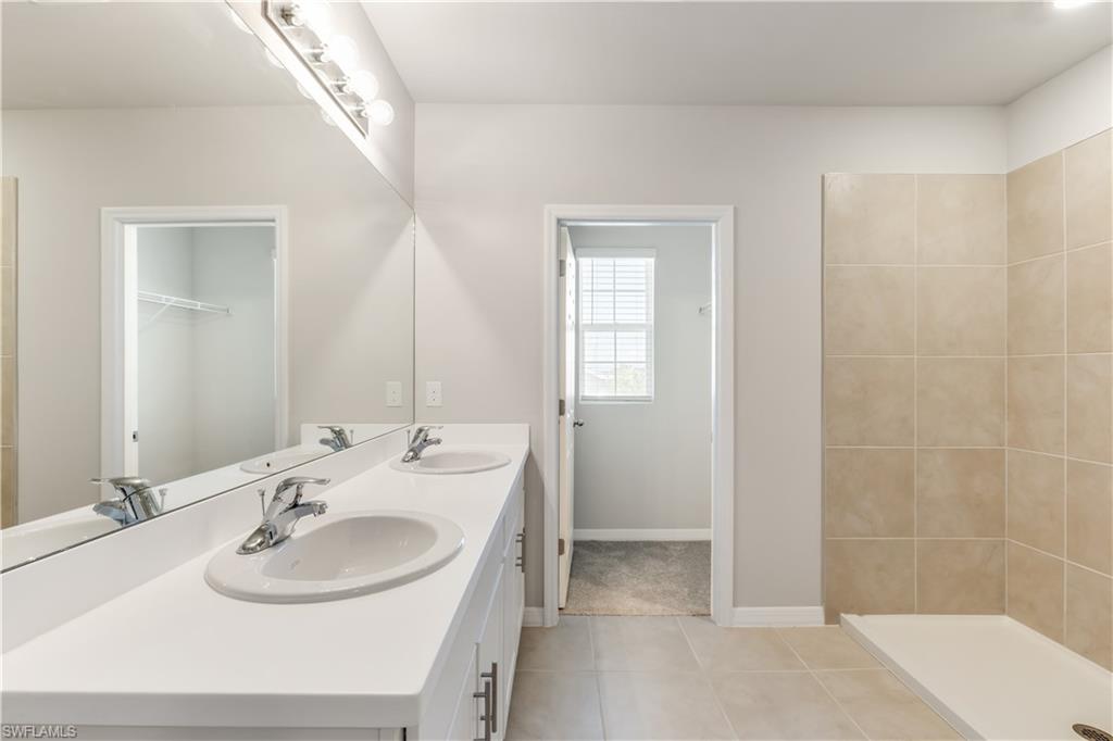 17764 Shade Tree Loop Punta Gorda, FL 33982 - Photo 20 of 48 a bathroom with a sink and a mirror