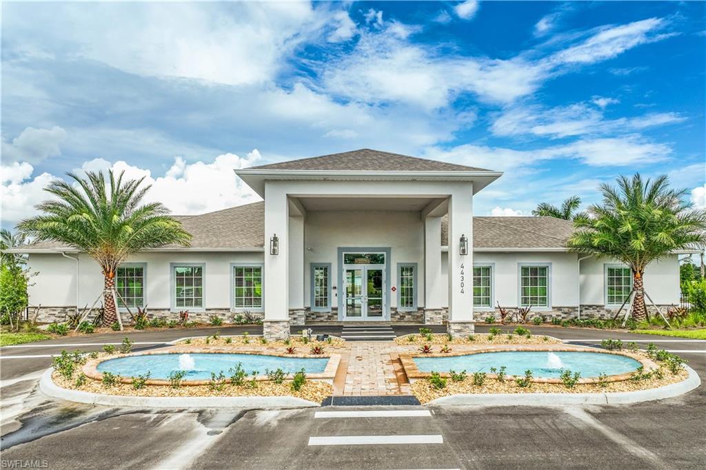 17764 Shade Tree Loop Punta Gorda, FL 33982 - Photo 23 of 48 a view of a white house with a large pool and a large tree with plants
