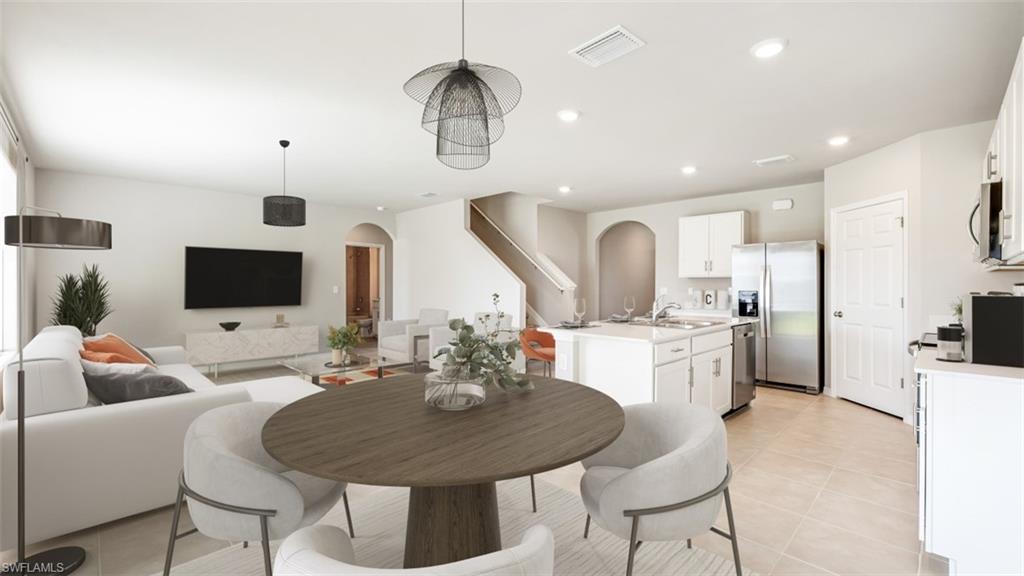 17764 Shade Tree Loop Punta Gorda, FL 33982 - Photo 4 of 12 Dining area featuring arched walkways, recessed lighting, and light tile patterned floors
