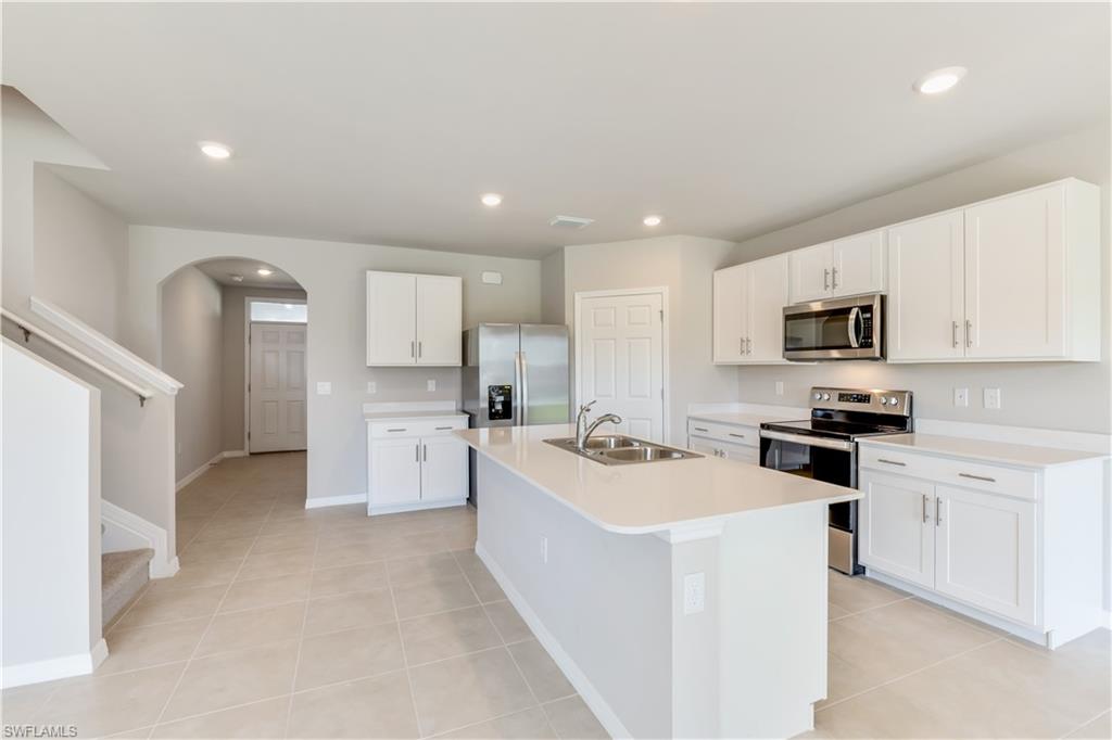 17764 Shade Tree Loop Punta Gorda, FL 33982 - Photo 7 of 48 a kitchen with a sink stove and refrigerator