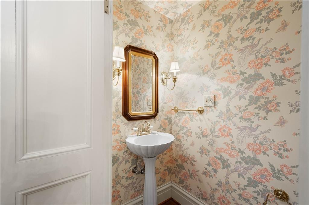 571 West McMurray Road Canonsburg, PA 15317 - Photo 14 of 47 A hallway powder room is under the stairs with vintage inspired pedestal sink and wall paper.