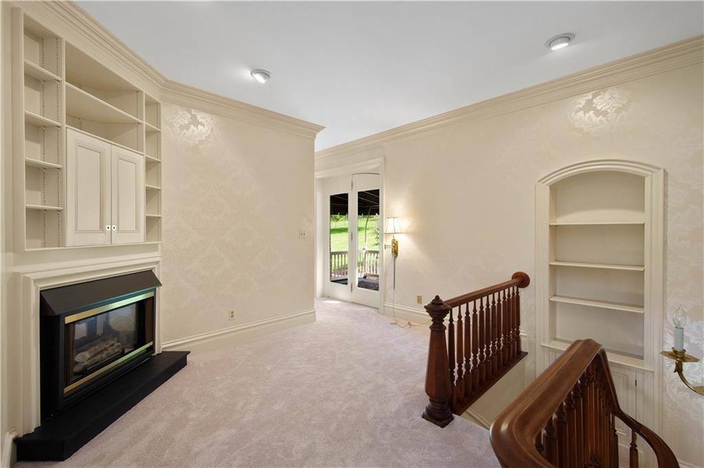 571 West McMurray Road Canonsburg, PA 15317 - Photo 19 of 47 At the top of the stairs there is a sitting area with fireplace, built in cabinet and book case.