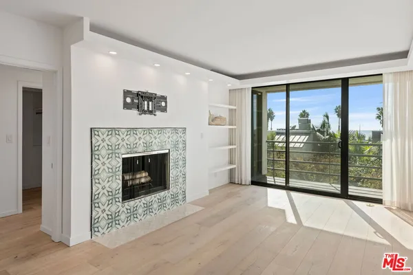 a view of a livingroom with a fireplace window and front door