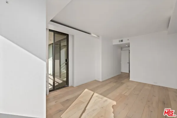 a view of a room with wooden floor and windows