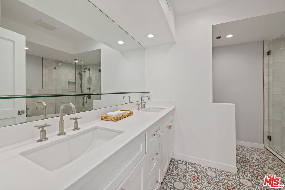 2920 Neilson Way, Unit 303 Santa Monica, CA 90405 - Photo 16 of 34 a bathroom with a sink and a mirror
