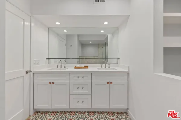 a bathroom with a sink a vanity and a mirror