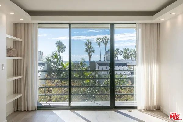 a view of a balcony with wooden floor and city view