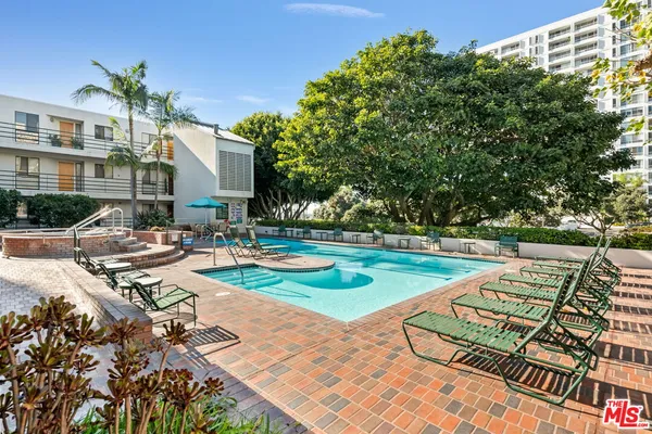 a view of a patio with chairs and a table