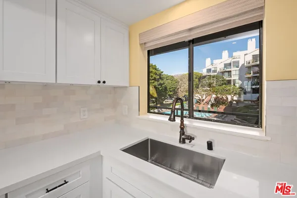 a kitchen with a sink and cabinet