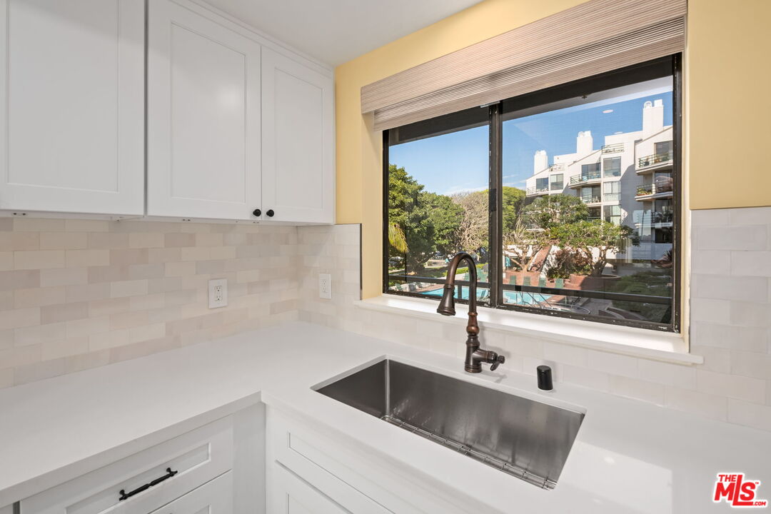 2920 Neilson Way, Unit 303 Santa Monica, CA 90405 - Photo 10 of 34 a kitchen with a sink and cabinet