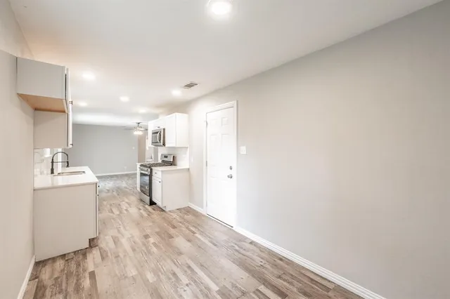 a kitchen with a refrigerator and a sink