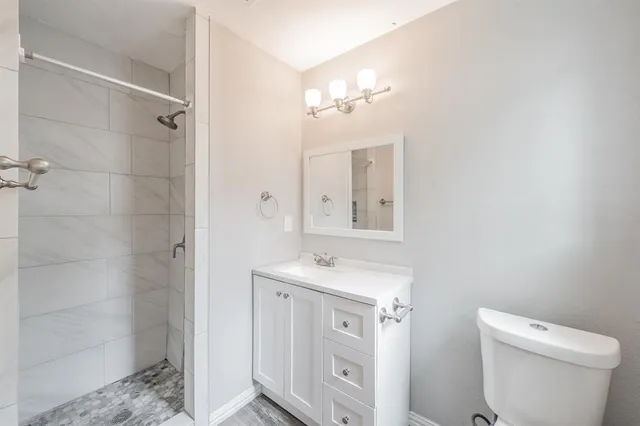 a bathroom with a sink mirror and shower