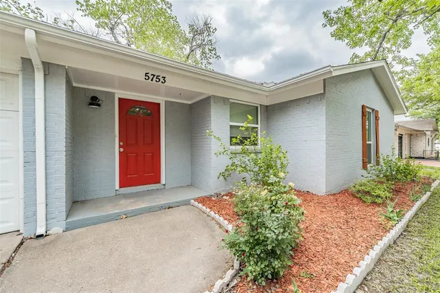 front view of a house with a garden