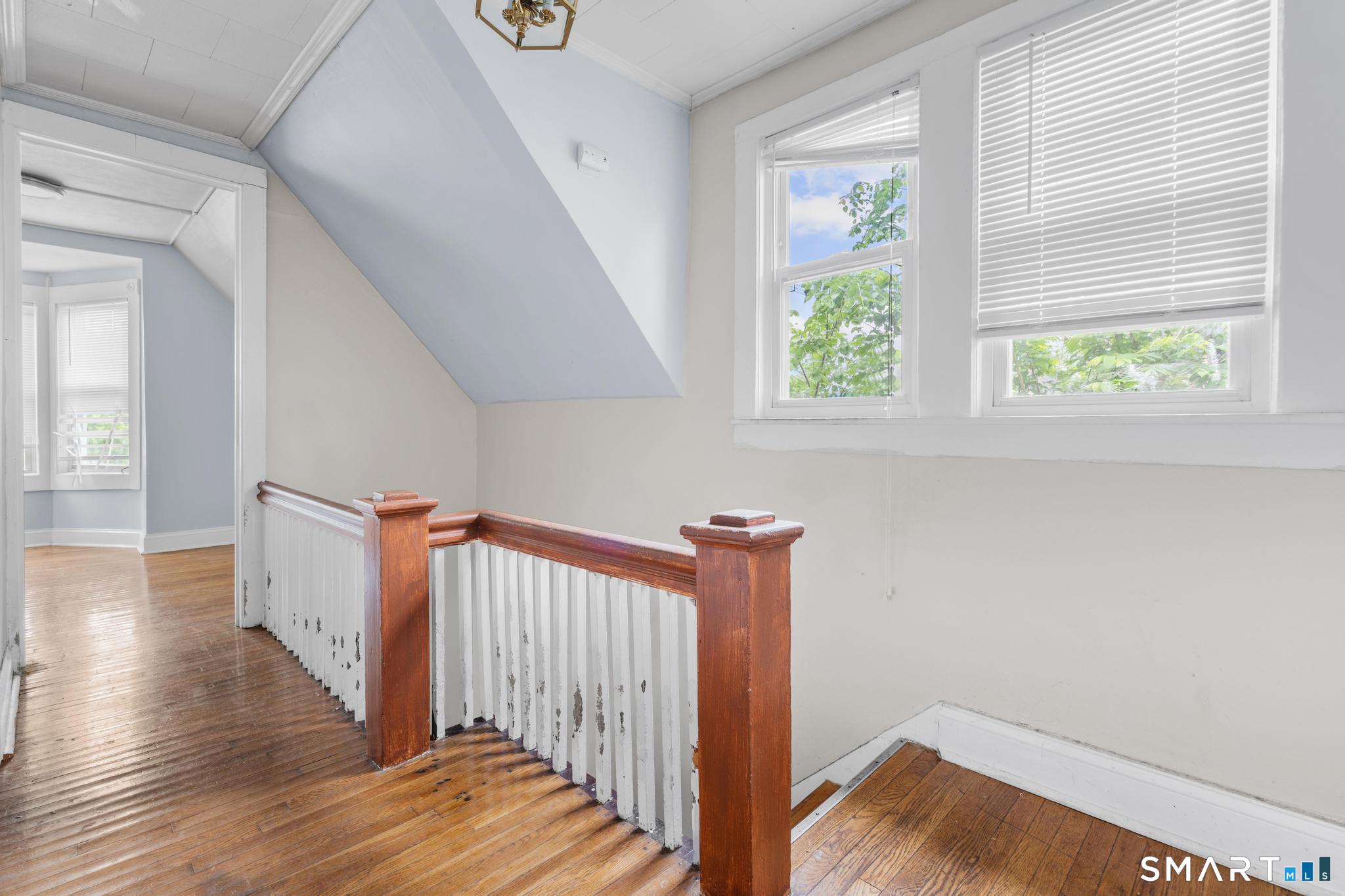 101 Meridian Street Meriden, CT 06451 - Photo 17 of 26 a view of a hallway with wooden floor and staircase