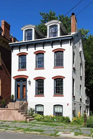 a front view of a house with a yard