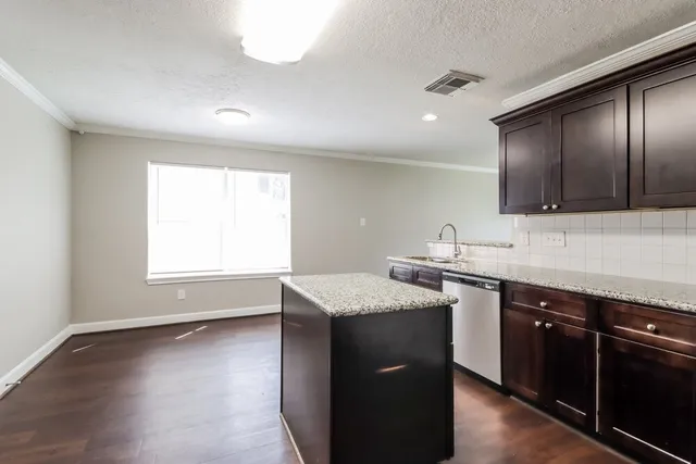 a kitchen with a sink stove and cabinets