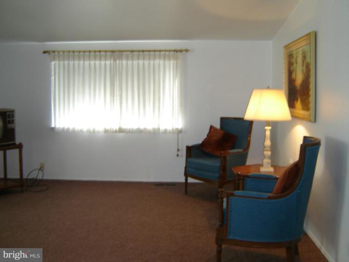 2002 Kennicott Road Windsor Mill, MD 21244 - Photo 13 of 27 a living room with furniture and a lamp