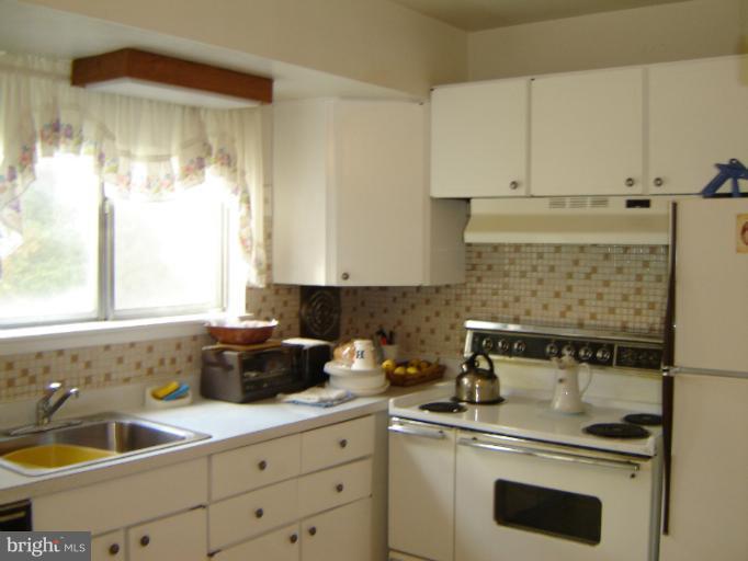 2002 Kennicott Road Windsor Mill, MD 21244 - Photo 4 of 27 a kitchen with a sink and cabinets