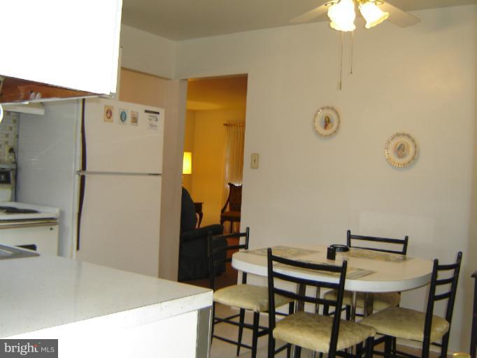 2002 Kennicott Road Windsor Mill, MD 21244 - Photo 10 of 27 a white kitchen with a refrigerator a stove a washer and dryer